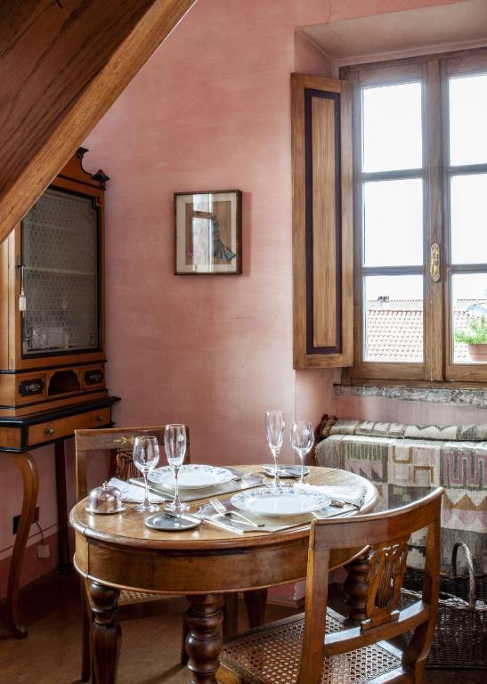 a dining room with a table with wine glasses on it at Hotel Locanda Dei Mai Intees in Azzate