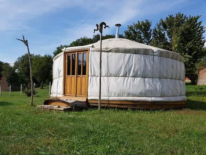 a yurt sitting in the grass in a field at Nomád jurta Zalakaros mellett in Zalamerenye