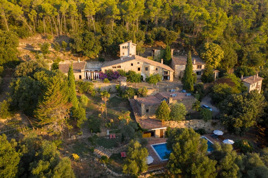 an aerial view of a large house with a pool at Masia Can Pou in Canet de Adri