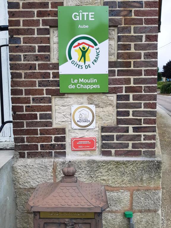 a sign on the side of a brick building at Moulin de Chappes in Chappes