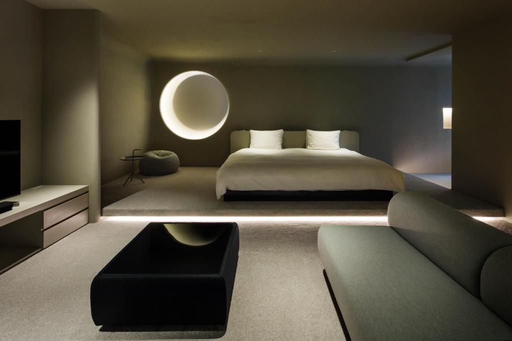 a bedroom with a large bed and a couch at The Screen in Kyoto