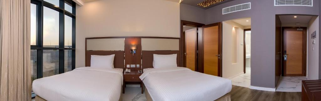 Postel nebo postele na pokoji v ubytování Muscat Gate Hotel
