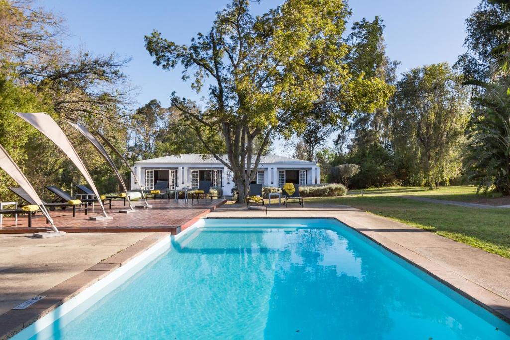 a swimming pool in the backyard of a house at Bloomestate Swellendam in Swellendam