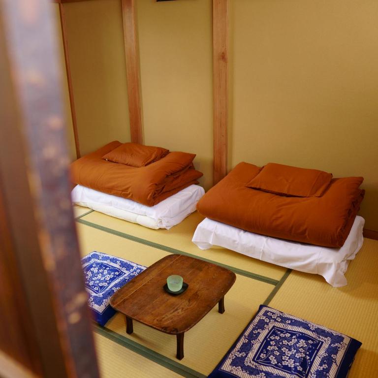 Postel nebo postele na pokoji v ubytování Kinoya Hostel