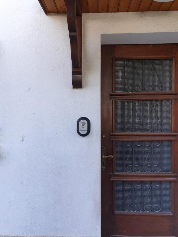 a door with a sign on the side of a building at Appartement T2 in Lau-Balagnas