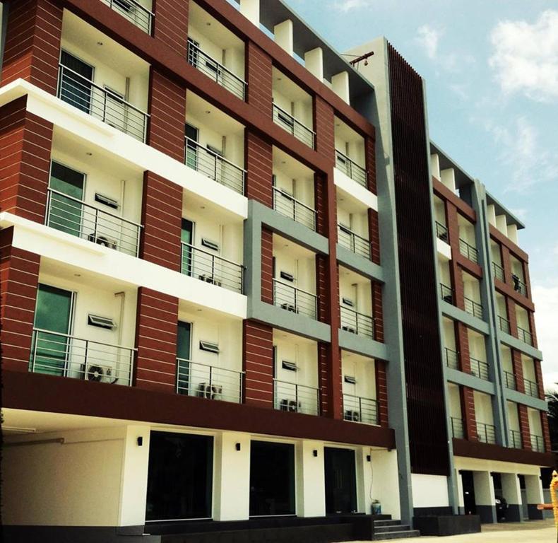 a tall building with balconies on the side of it at Smith Residence in Suratthani