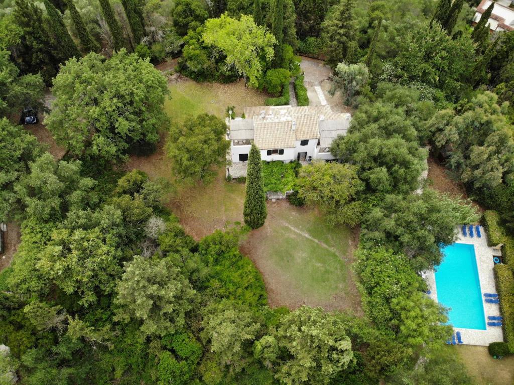 an aerial view of a house with a swimming pool in the forest at Alexandra villas in Gouvia