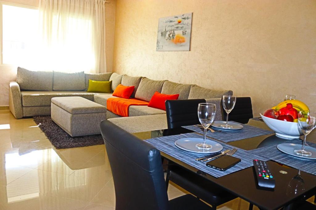 a living room with a table and a couch at Appartement Standing Quartier Tour Hassane (près Marina) in Rabat