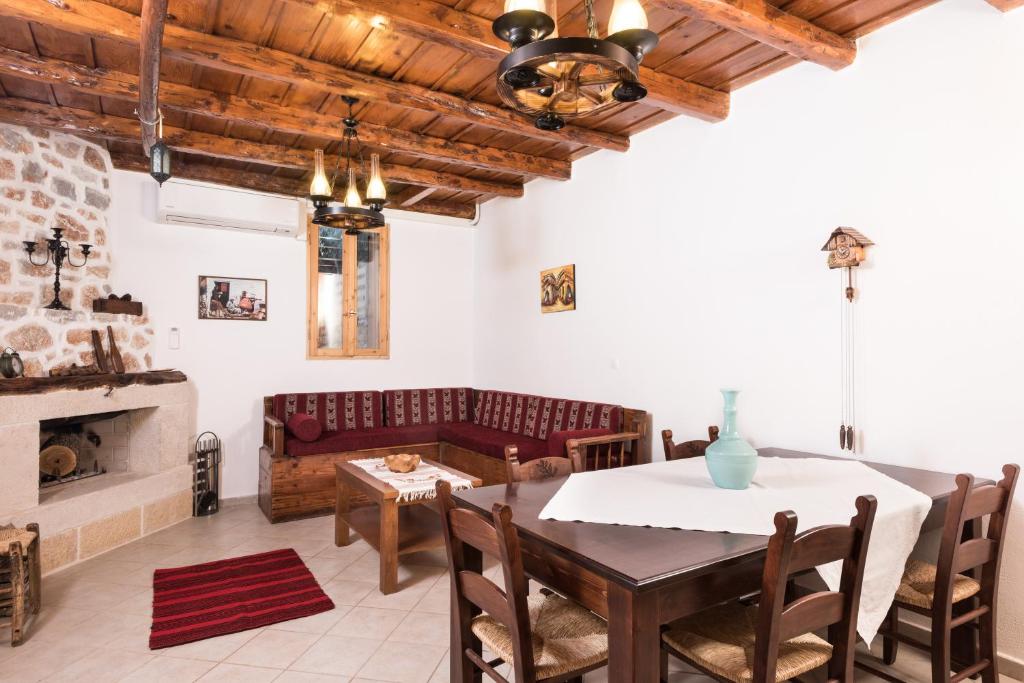 a living room with a table and a couch at ARADENA TRADITIONAL House 2 in Arádhaina