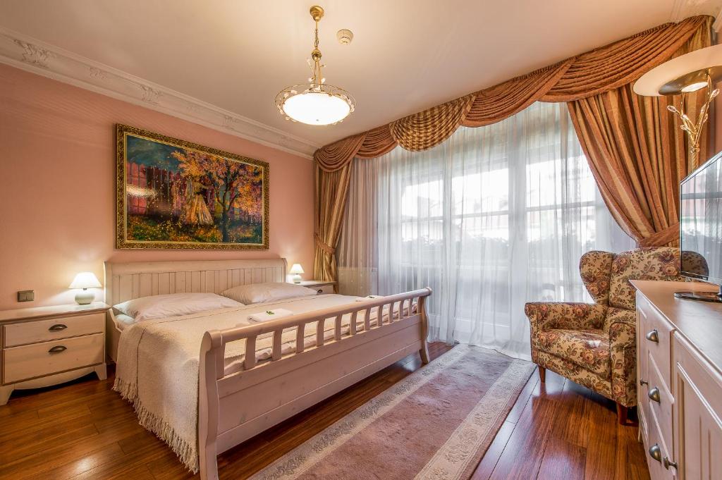 a bedroom with a bed and a chair at Boutique Hotel Carpe Diem in Prešov