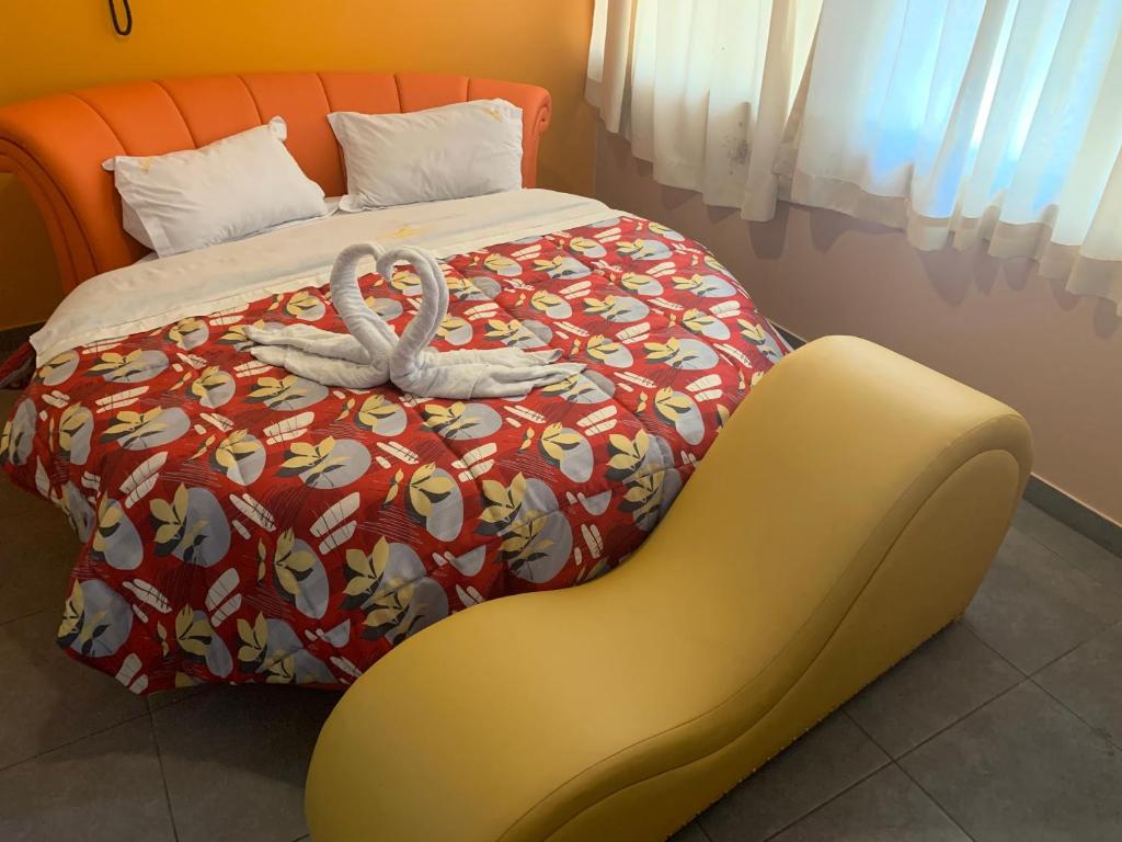 ein Schlafzimmer mit einem Bett mit zwei Schwänen darauf in der Unterkunft Manantail Hotel No.003 in Puente Piedra