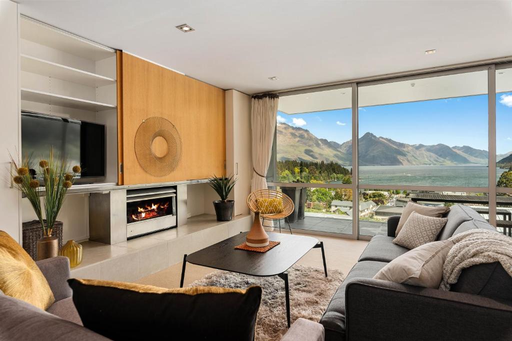 a living room with a couch and a fireplace at Horoeka on Hallenstein in Queenstown