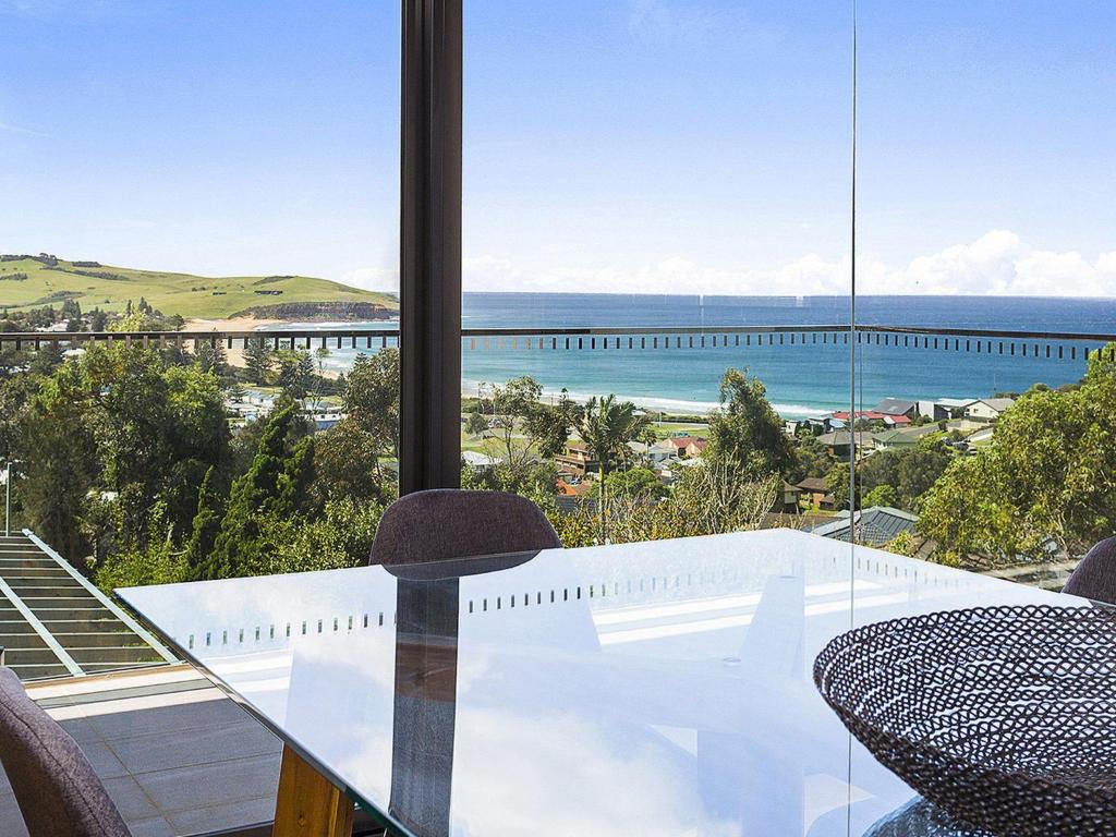 a dining room with a view of the ocean at Manhattan at SoHo in Gerringong