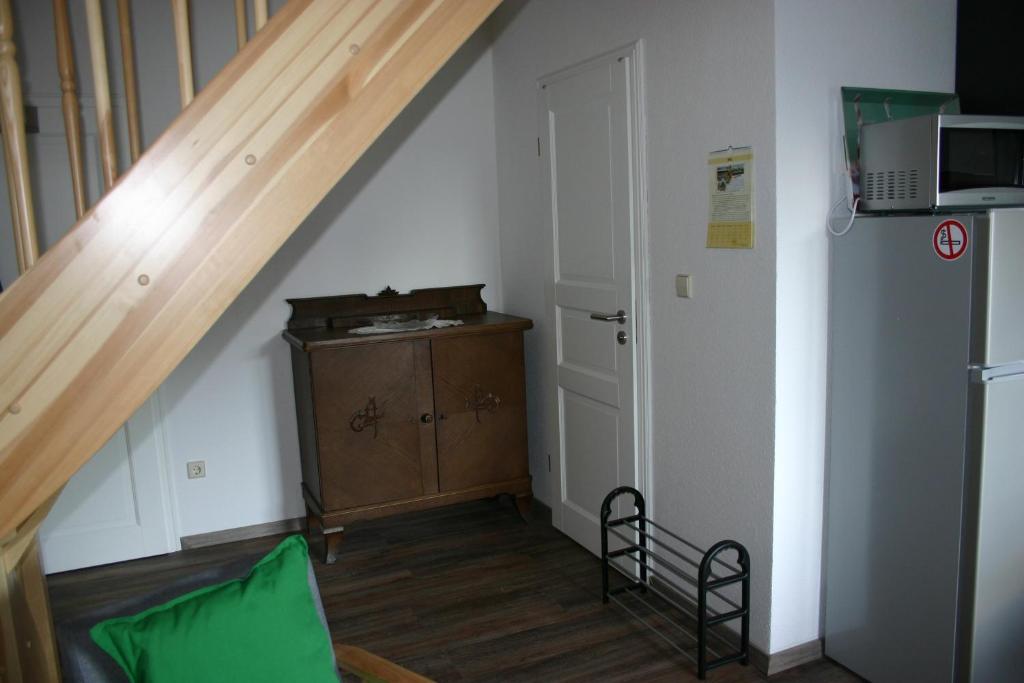 a room with a staircase and a cabinet and a door at Apartment Jakobsweg GbR in Pettstädt