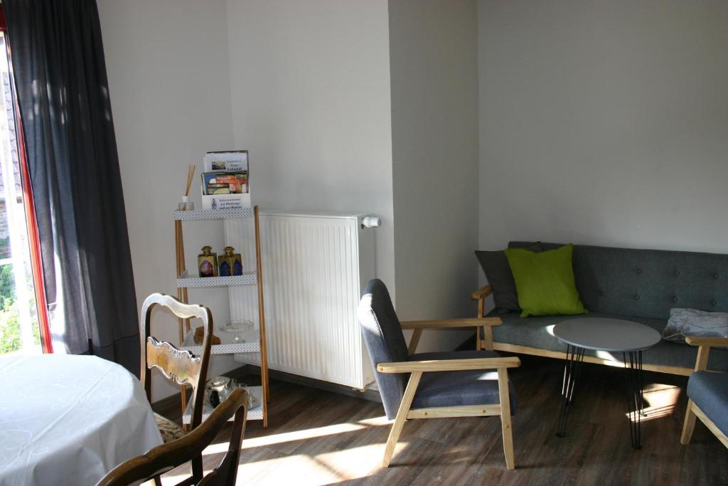 a living room with a couch and a table at Apartment Jakobsweg GbR in Pettstädt
