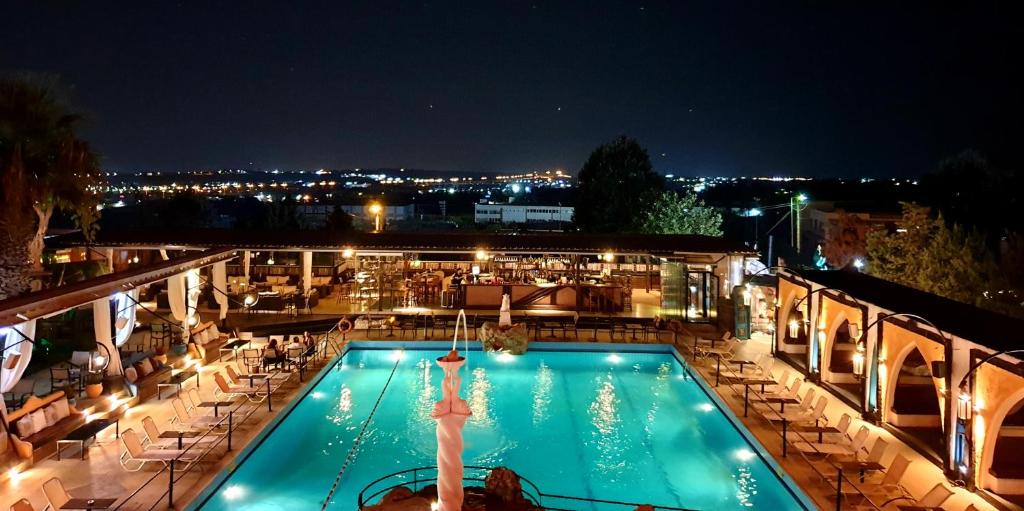 a view of a swimming pool at night at Nouvelle in Oraiokastro