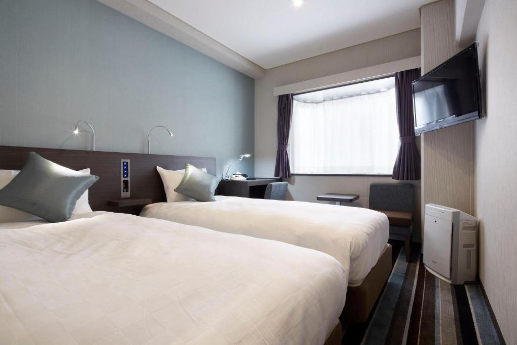 a hotel room with two beds and a window at Shinagawa Prince Hotel N Tower in Tokyo