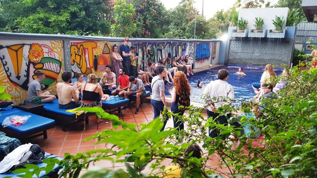 a group of people sitting in a swimming pool at Siem Reap Pub Hostel in Siem Reap