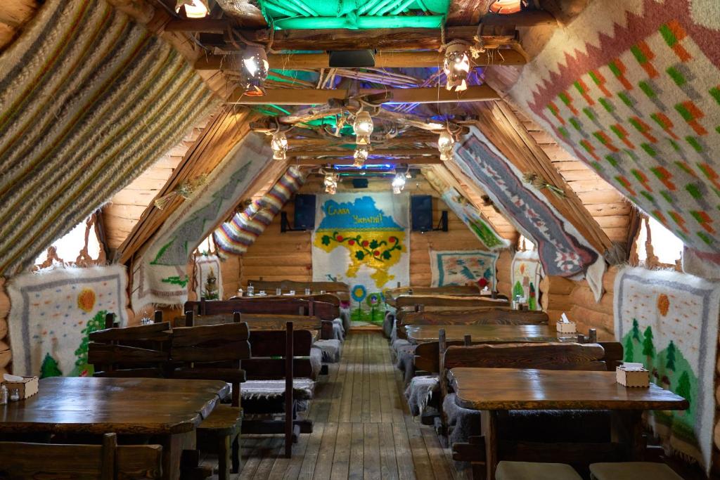 an inside view of a restaurant with wooden tables and chairs at Ra in Bukovel