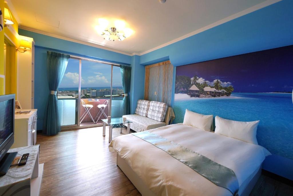 a hotel room with a large bed and a window at Jia Jia House in Kaohsiung