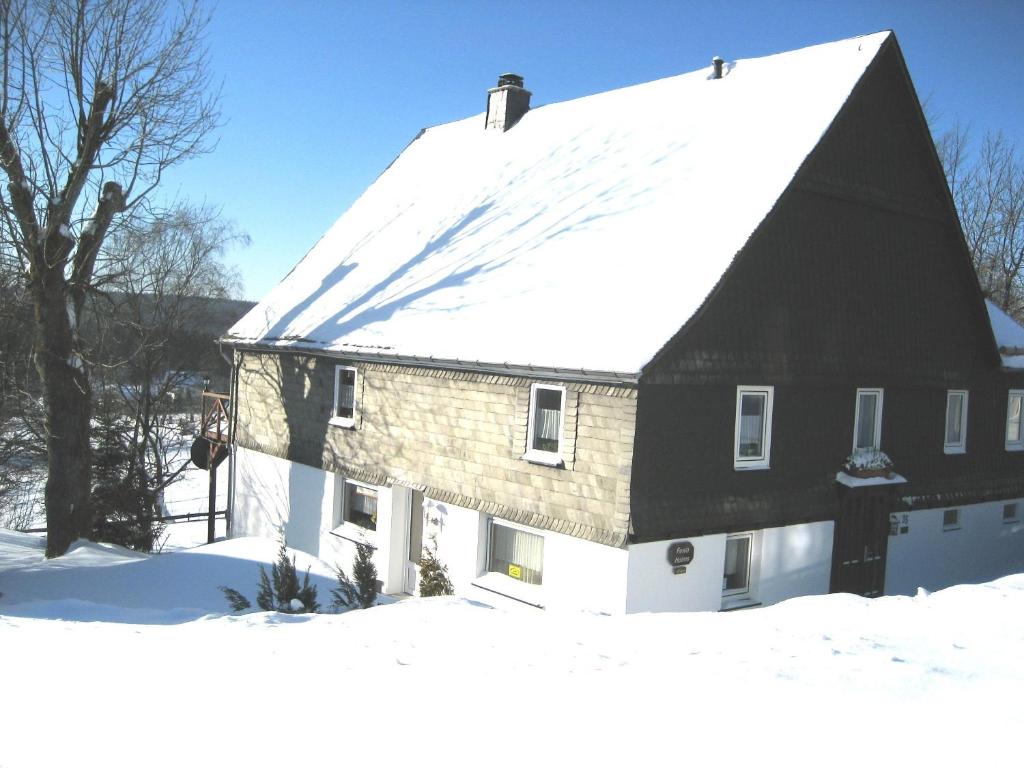 a black and white house in the snow at Fewo Holms in Winterberg