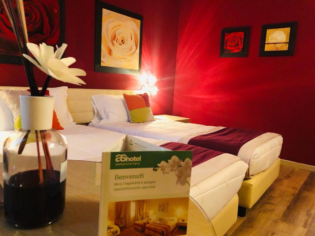 Postel nebo postele na pokoji v ubytování AS Hotel Sempione Fiera