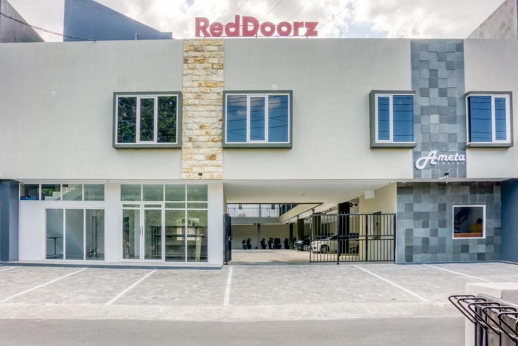 a rendering of a building with a red door at RedDoorz @ Plemburan Jakal 2 in Yogyakarta