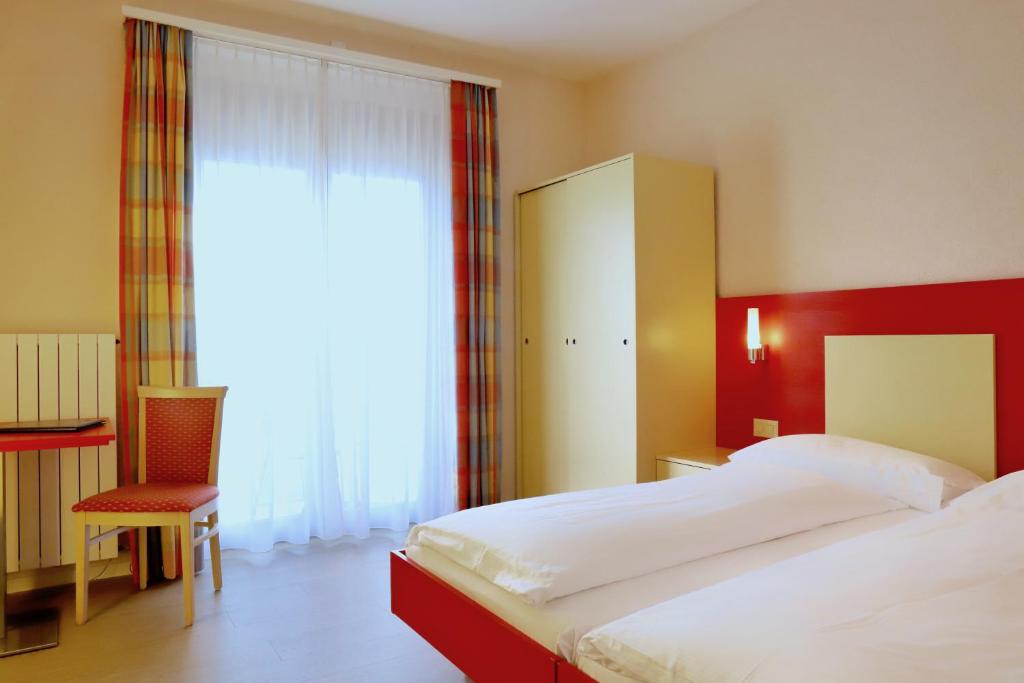 Postel nebo postele na pokoji v ubytování Hotel Arancio