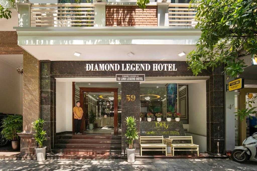 a hotel entrance with a sign that reads dalmond legend hotel at Diamond Legend Hotel in Hanoi