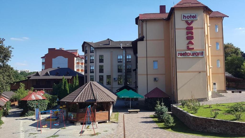 a hotel with a playground in front of a building at versal in Ternopil