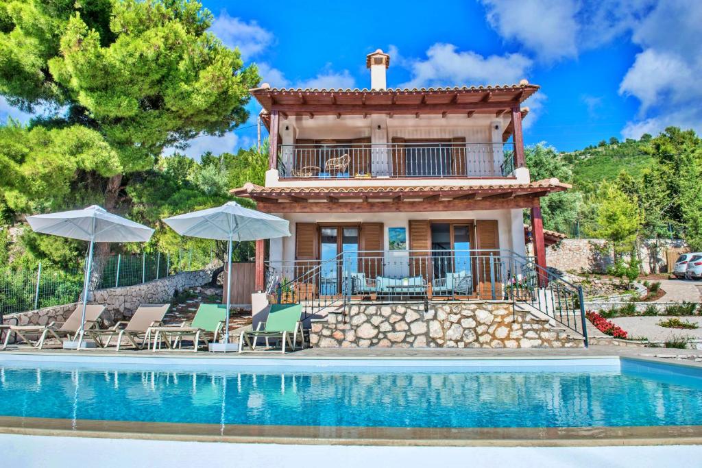 a villa with a pool and a house at Villa Agapi in Athanion