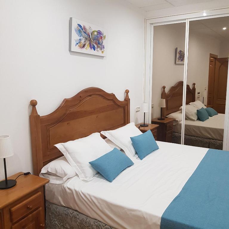 Postel nebo postele na pokoji v ubytování Hostal La Parada