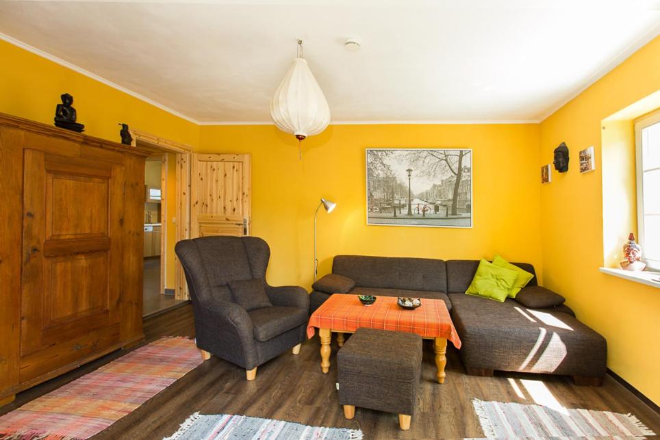 a living room with a couch and a chair at Hügelhus in Kloster