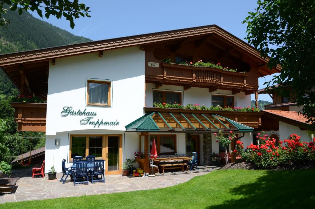 a guest house in the mountains with a patio at Gästehaus Troppmair in Finkenberg