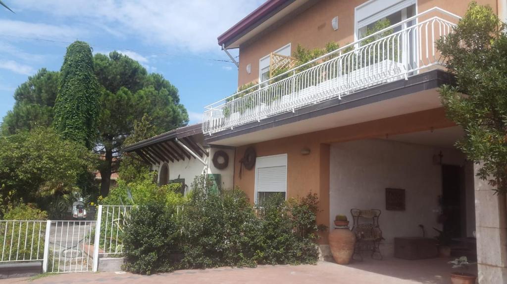 a house with a balcony on top of it at La Finestra Sull'Etna in Motta SantʼAnastasia