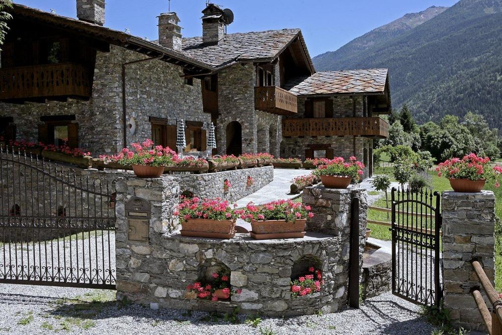 a stone house with flowers on a fence at VillAmour Boutique Hotel & SPA in La Salle
