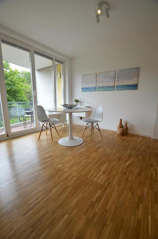 an empty living room with a table and chairs at Fair Apartment MAX 33 in Meerbusch