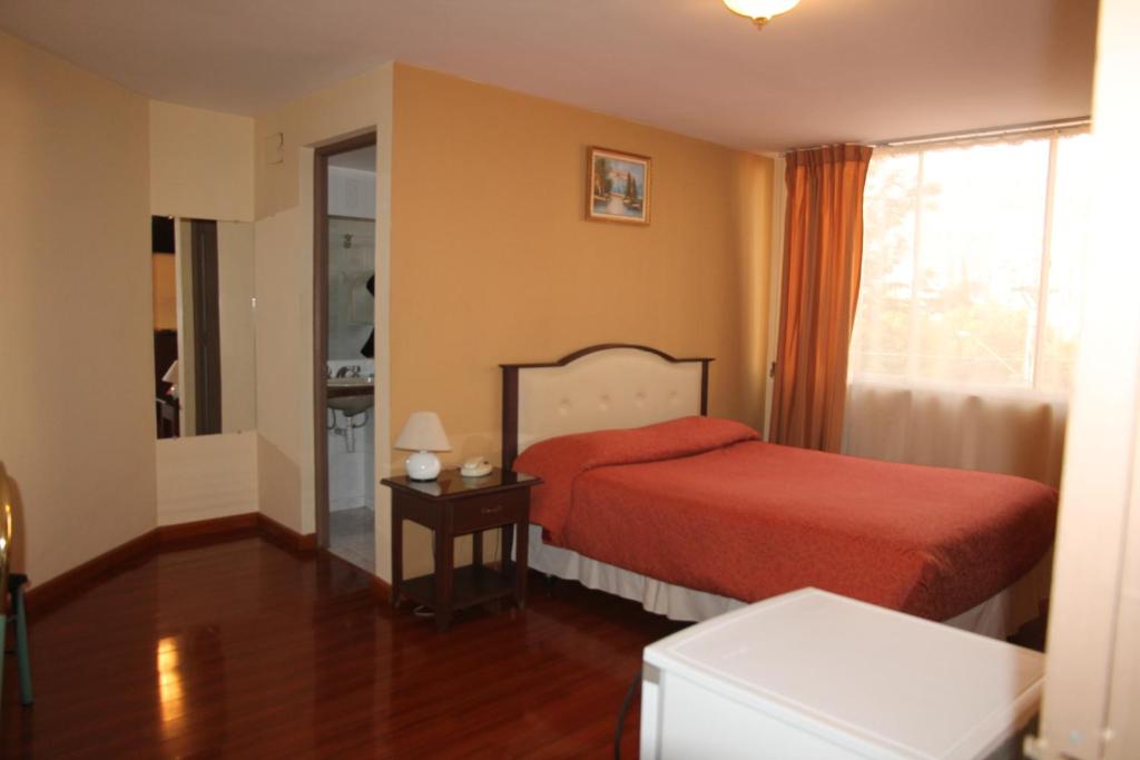 Кровать или кровати в номере Hotel Luxor