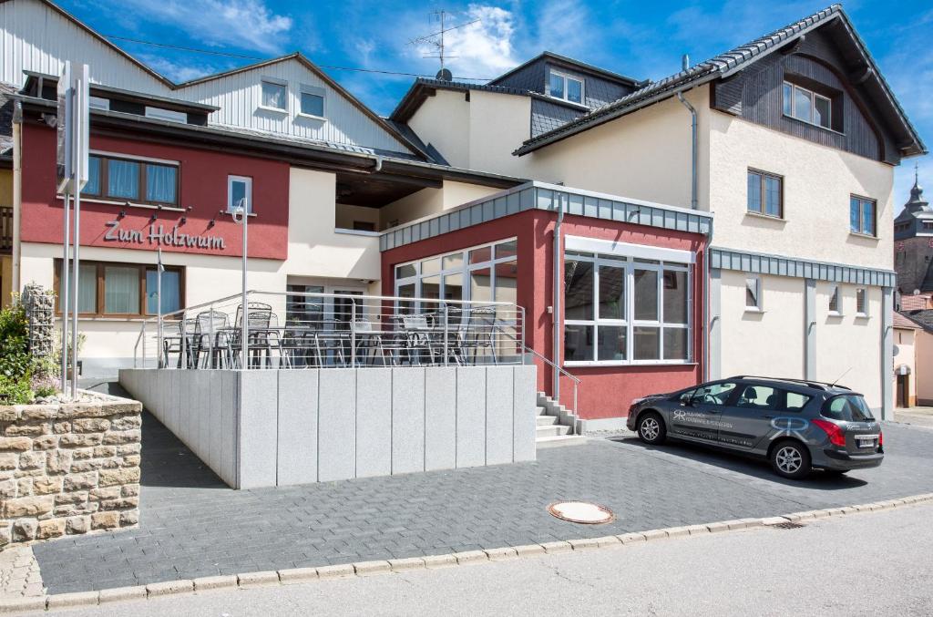 um carro estacionado em frente a um edifício em Gasthaus zum Holzwurm em Gransdorf