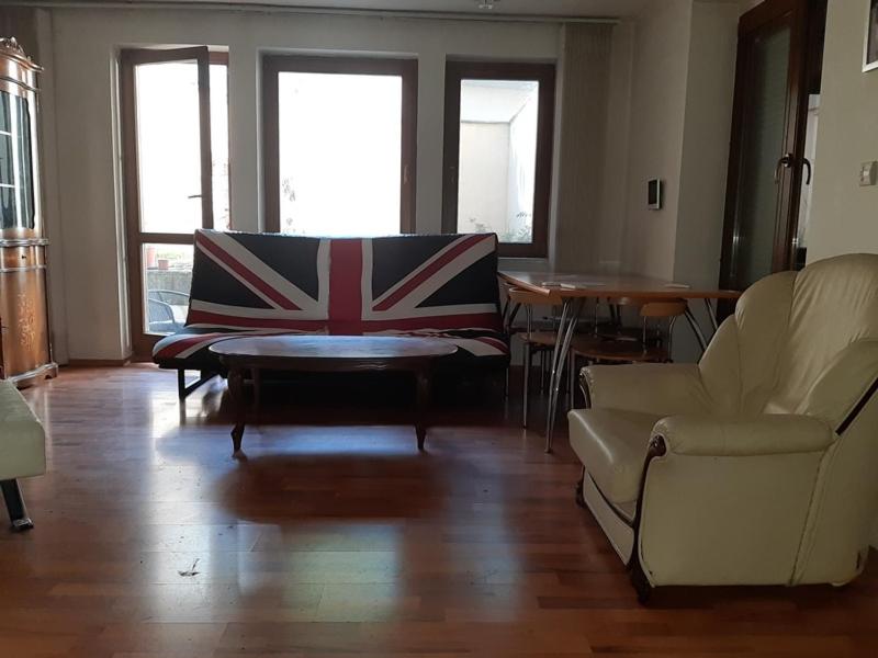 a living room with a couch and a table and chairs at Pleasant apartment under the Bratislava castle in Bratislava