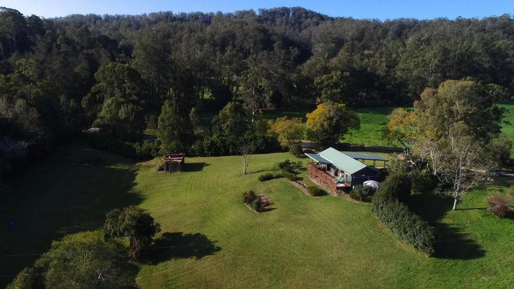 an aerial view of a farm with a truck in a field at Afterglow Cottages in Bellingen