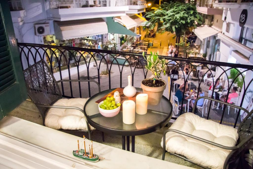 a table with candles and fruit on a balcony at Artistic Getaway Home - Super Central in Heraklio Town