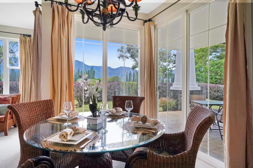 a dining room with a glass table and chairs at Plantations at Princeville #512 in Princeville