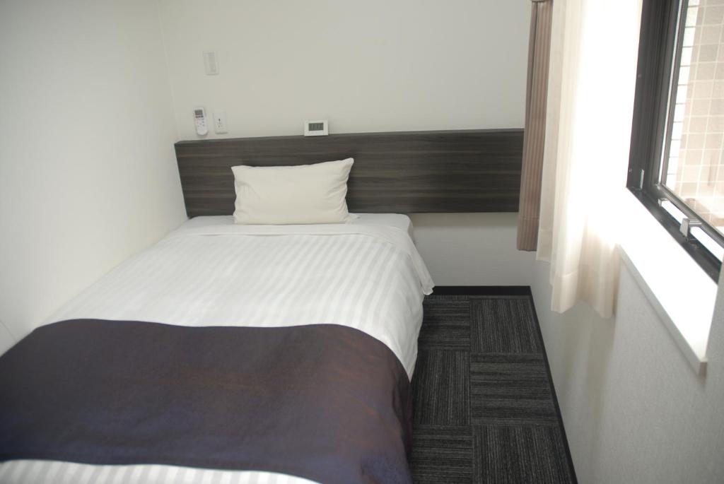 Postel nebo postele na pokoji v ubytování Okachimachi Urban Hotel