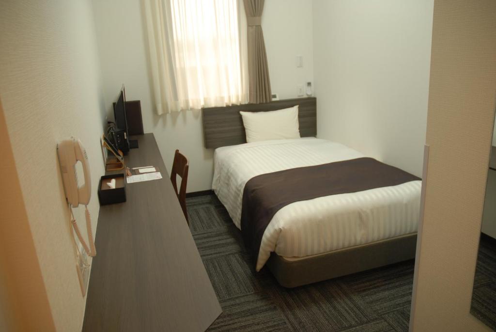 Postel nebo postele na pokoji v ubytování Okachimachi Urban Hotel