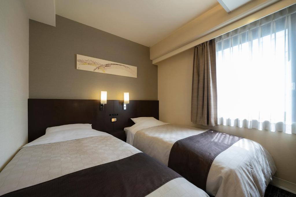 Postel nebo postele na pokoji v ubytování Hotel Binario Umeda