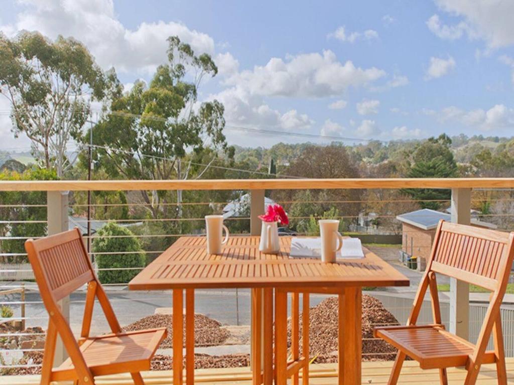 a wooden table and two chairs on a deck at Hahndorf Haven-Central Hahndorf in Hahndorf