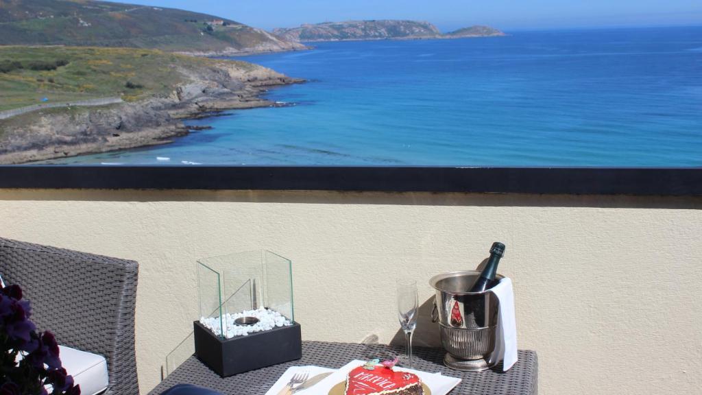 einen Tisch mit Meerblick und einem Bild in der Unterkunft Apartamento Malpica Area Grande in Malpica