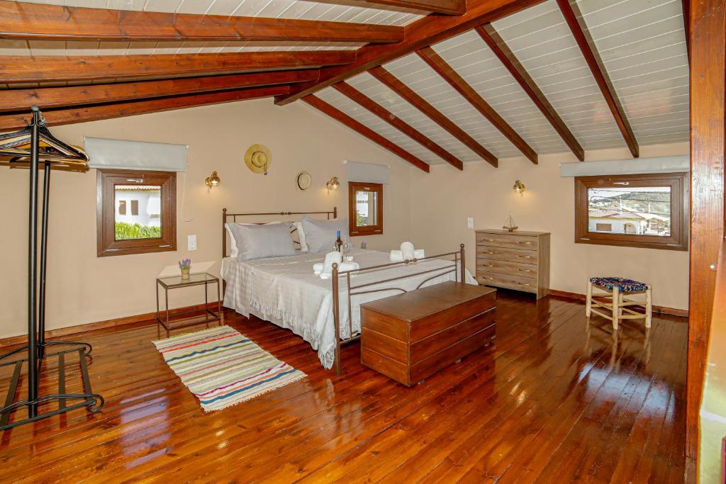 a bedroom with a bed and a wooden floor at Loft Sweet loft in Agios Nikolaos