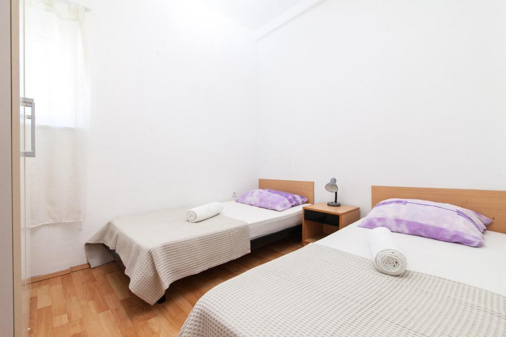 Posteľ alebo postele v izbe v ubytovaní Kuća Ella